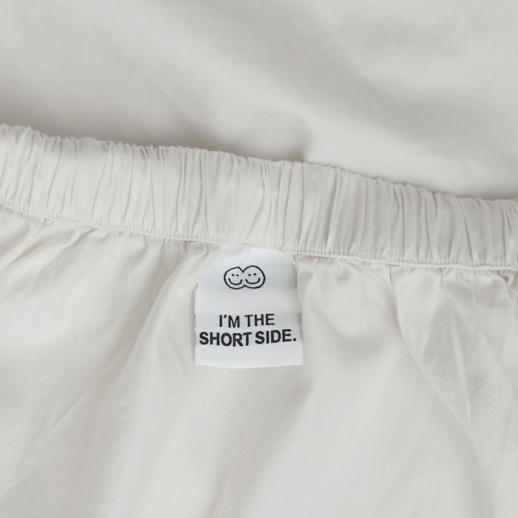 Roomie white organic cotton fitted sheet tag guide