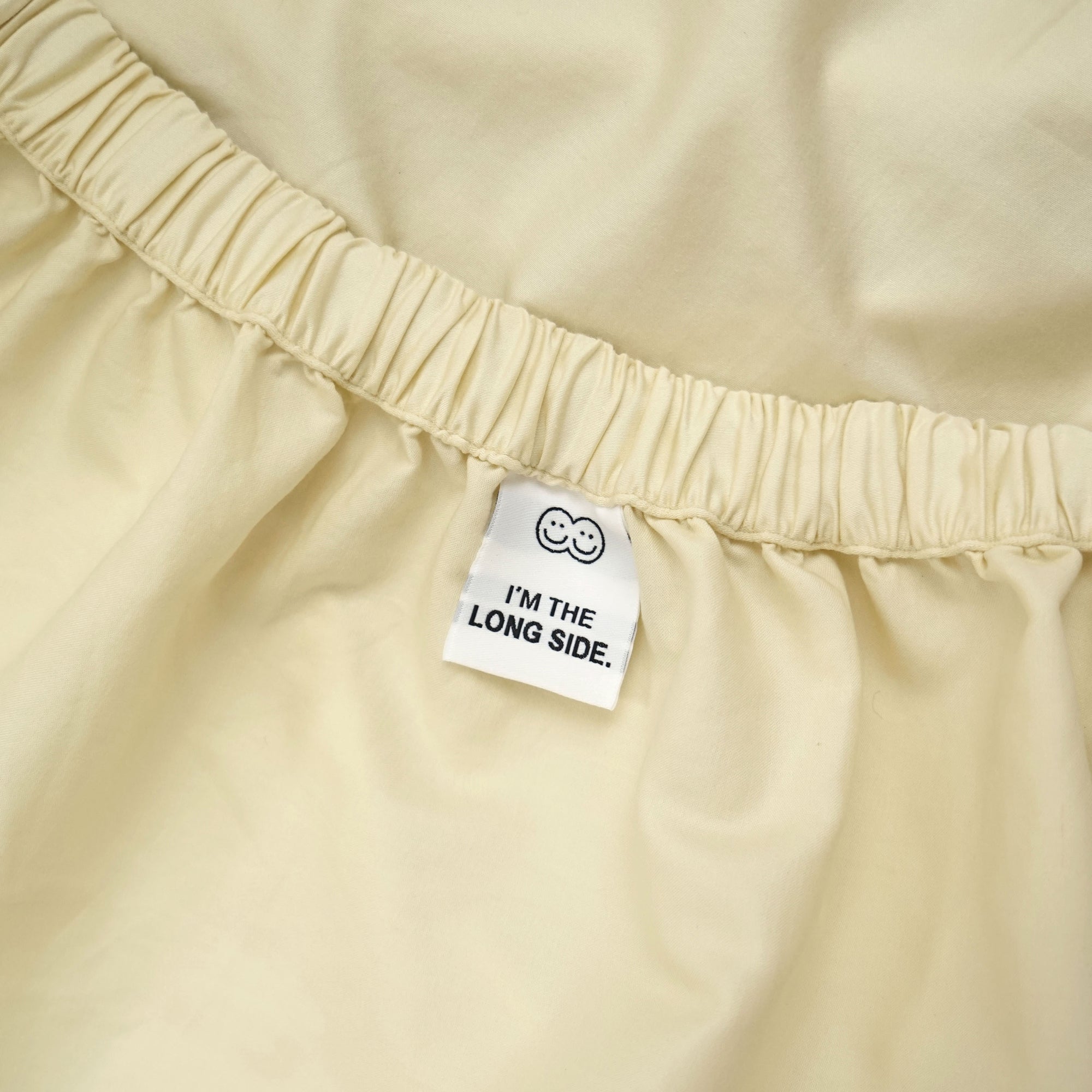 Roomie yellow butter organic cotton fitted sheet with tag guide
